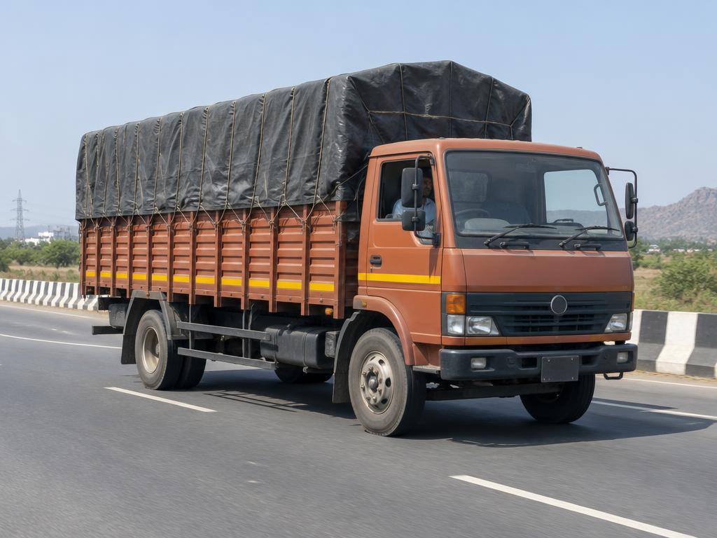 Illustrative image: medium covered goods truck on a highway
